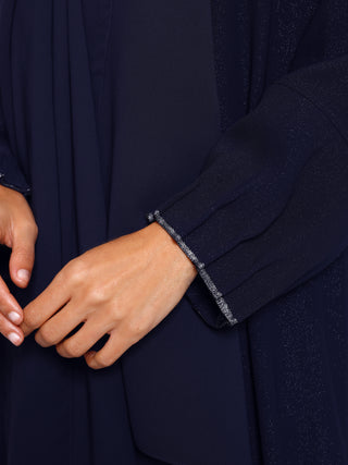 Detail view of metallic weave ribbon on abaya sleeve