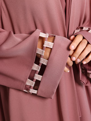 Detail view of metallic weave ribbon on abaya sleeve