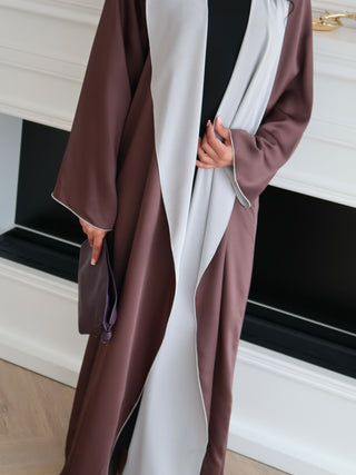 Close up of inside out abaya showing contrast satin and matte sides with fluid drape and relaxed elegant fit