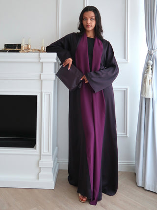 Reversible abaya in double sided silk with satin sheen, styled over black dress in elegant minimal interior