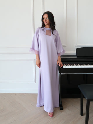 Lavender textured dress with organza inset details and relaxed silhouette, styled in minimal elegant interior