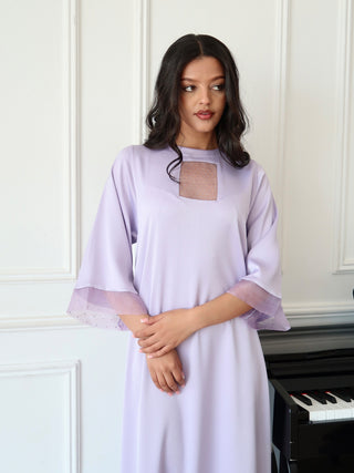 Close up of lilac dress with sheer organza panel and textured fabric, featuring soft drape and refined finish